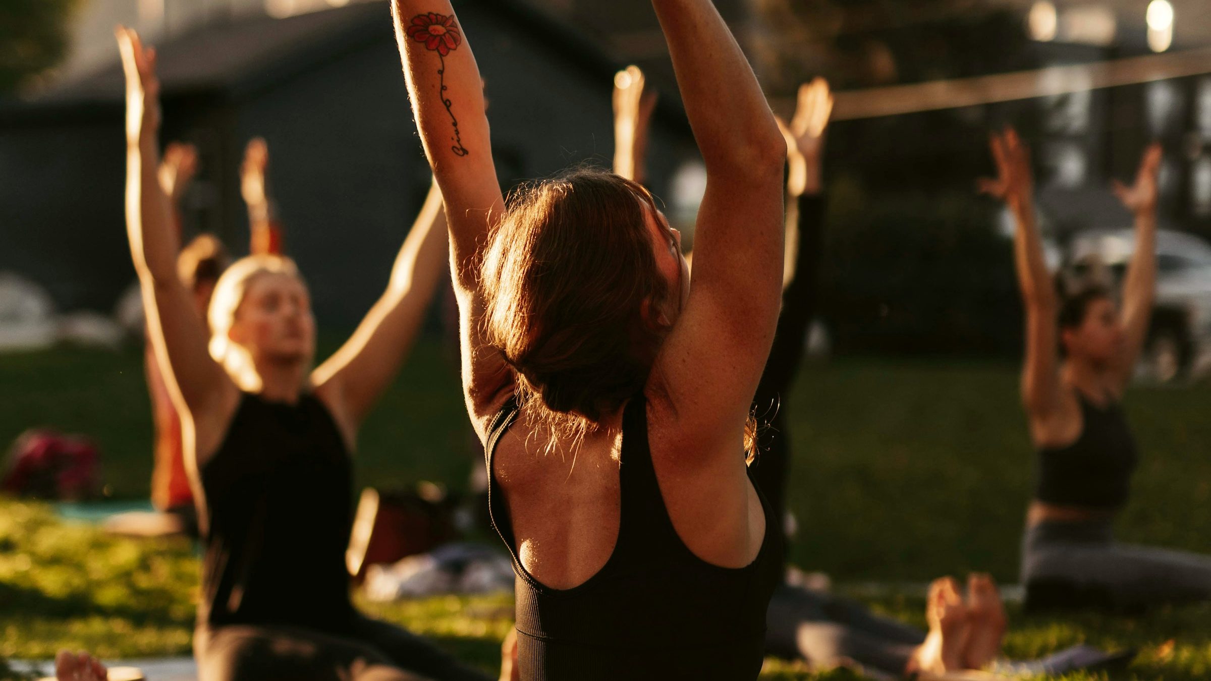 A yoga class practicing together in a park